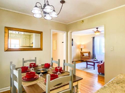 a dining room with a table with red dishes on it at Bonita Bungalow in Huntsville