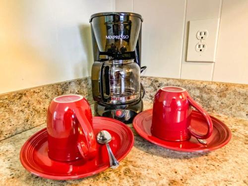 two red cups on a counter with a coffee maker at Bonita Bungalow in Huntsville