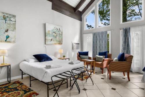 a bedroom with a bed and a living room at Observatory Drive Terrace House in Irondale
