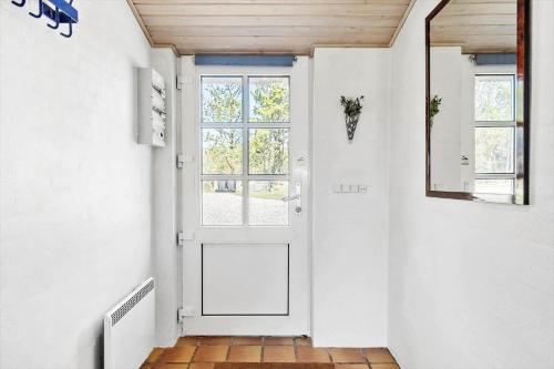a hallway with a white door and a mirror at 20712-Ulfborg-Knakvej-36 in Vedersø Klit