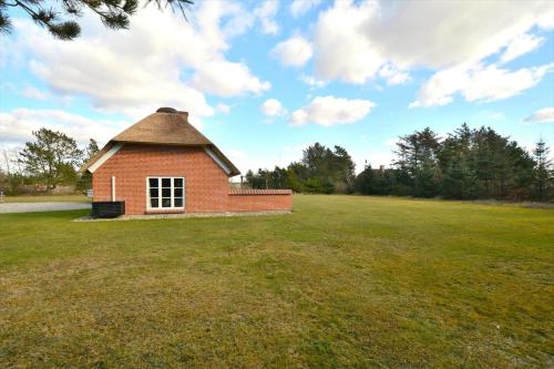 a small brick building in a grass field at 20712-Ulfborg-Knakvej-36 in Vedersø Klit