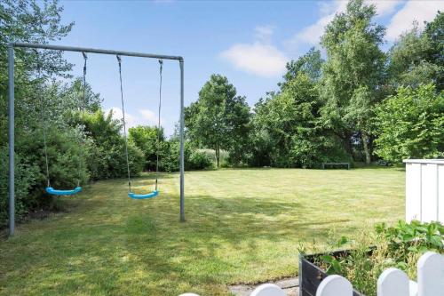 a swing in a yard with a field at 30401-Ulfborg-Klovervej-469 in Vang