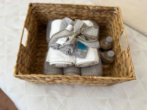 a basket with towels and a bow on it at Cozy 2-BR Retreat Private Parking Near Downtown in Wilmington