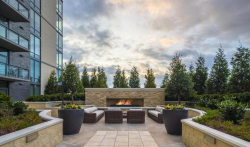 a patio with a fireplace in front of a building at The Stay 1 - Tysons Corner in Howard