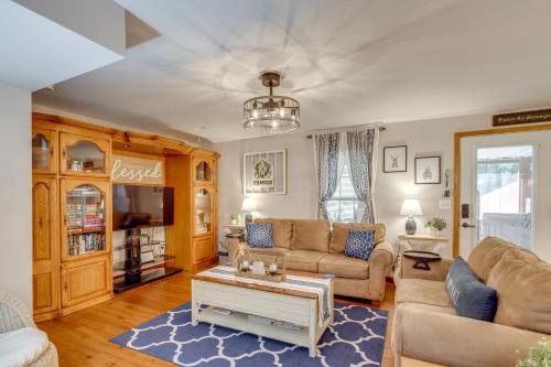 a living room with a couch and a table at Foxes Den with Hot Tub, Pool Table and Fire Pit! in Troy