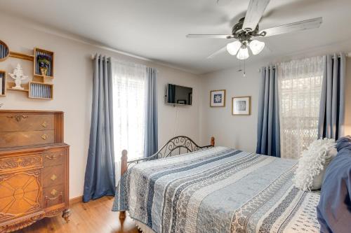 a bedroom with a bed and a ceiling fan at Foxes Den with Hot Tub, Pool Table and Fire Pit! in Troy