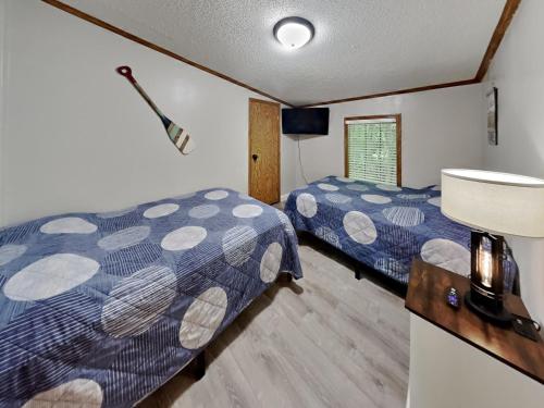 a bedroom with two beds and a sink at Island Club #102 in Put-in-Bay