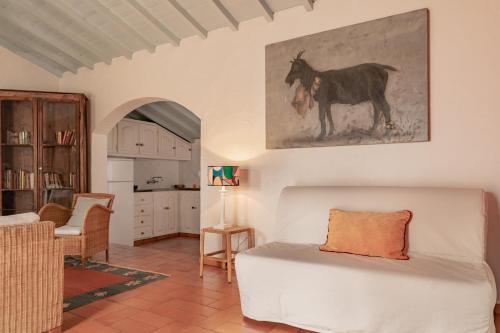 a living room with a couch and a horse on the wall at CABRA - Porto Covo in Porto Covo