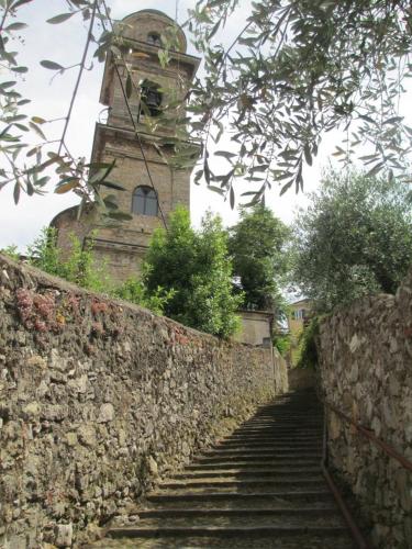 a stone wall with stairs leading up to a tower at La Spezia Marola Un Borgo Sul Mare in La Spezia