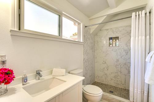 a bathroom with a sink and a toilet and a window at Walk to Dimond District Gems Home in Oakland in Oakland