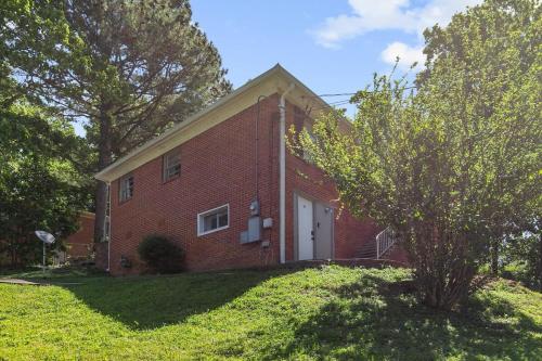 una casa di mattoni rossi con una porta bianca di Broadmoor Bungalow - Both Units a Center Point