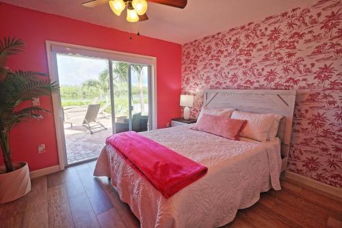 a bedroom with a bed with a red wall at Paradise with a pool, pier and private beach area in Osprey