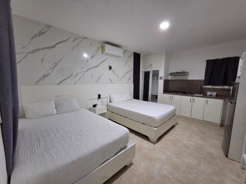 a bedroom with two beds and a marble wall at Costa Love Hotel Aeropuerto in Punta Cana