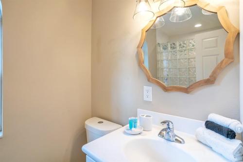 a bathroom with a sink and a mirror at Paradise with a pool, pier and private beach area in Osprey