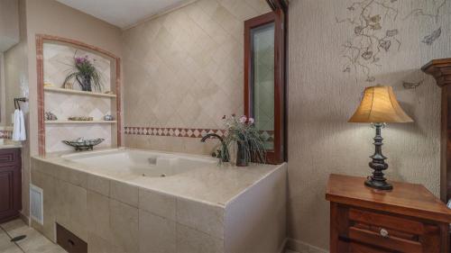 a large bath tub in a bathroom with a lamp at Sonoran Sky in Puerto Peñasco