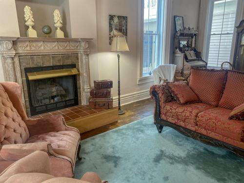 a living room with two couches and a fireplace at Restored historic home near ND and Amish Country in Elkhart