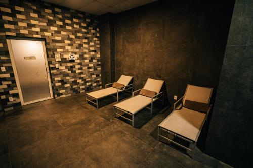 a waiting room with chairs and a door at Hilton Garden Inn Praia Brava in Itajaí