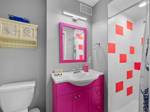 a bathroom with a pink cabinet and a sink at Spacious Unique Heated Pool 2 Hot Tubs Pkg in Sarasota