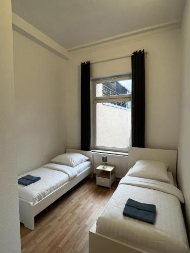 Katil atau katil-katil dalam bilik di CityStay Bergisch Gladbach Apartments & Rooms