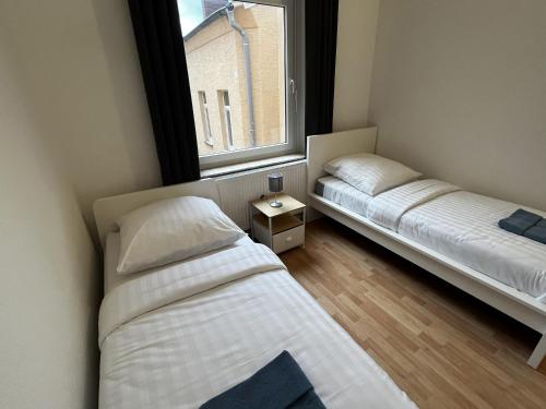 Katil atau katil-katil dalam bilik di CityStay Bergisch Gladbach Apartments & Rooms