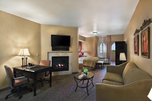 a hotel room with a living room with a fireplace at Oxford Suites Boise in Boise