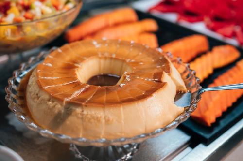 a close up of a cake in a bowl with a fork at Hilton Garden Inn Praia Brava in Itajaí