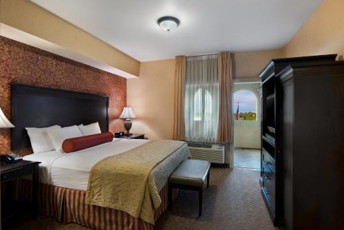 a hotel room with a bed and a window at Oxford Suites Boise in Boise