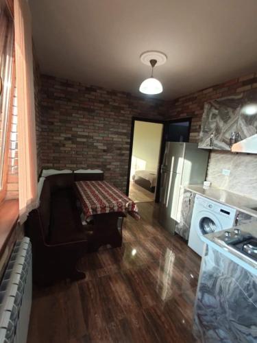 a kitchen with a couch and a washer and dryer at частный дом, с двором in Vanadzor