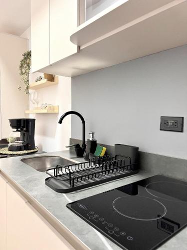 a kitchen with a stove and a sink at BIT by Simple stay in Medellín