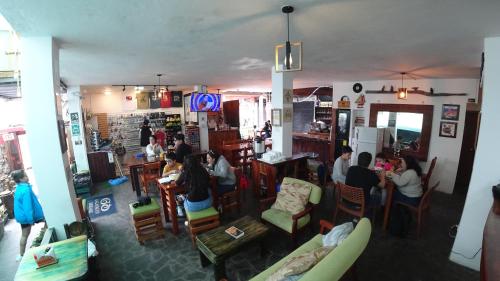 a group of people sitting at tables in a restaurant at Galapagos Dreams in Puerto Ayora