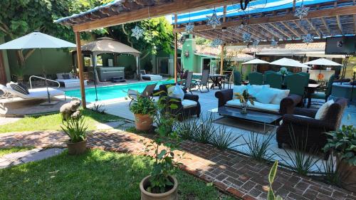 a backyard with a pool and a patio with furniture at Hacienda del Lago Boutique Hotel in Ajijic