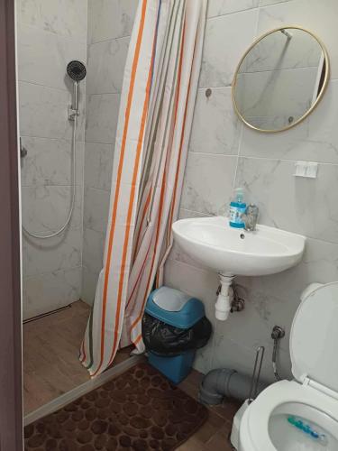 a bathroom with a shower curtain and a sink at IDEAL in Płock