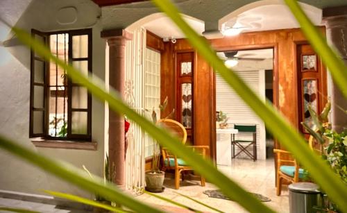 a living room with a table and chairs at Relaxing Suite in Cancun Downtown in Cancún
