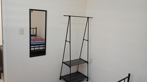 a mirror on a wall next to a shelf at Casa Alcatraz con Alberca, Cuernavaca Morelos in Tezoyuca