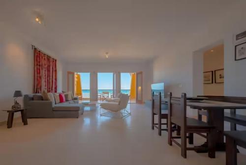 a living room with a table and a dining room at Luxury Stays in New Marina, El Gouna in Hurghada