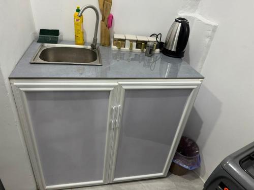 a kitchen counter with a sink and a sink at Home away from home-Jambiani in Paje