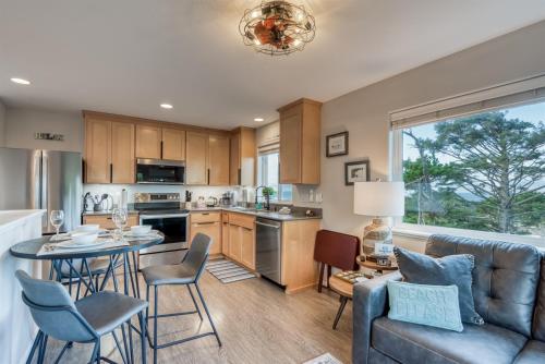 a kitchen and living room with a couch and a table at Pacific Peeks 2 - Oceanview Pet Friendly Retreat with EV Charging fee in Lincoln City