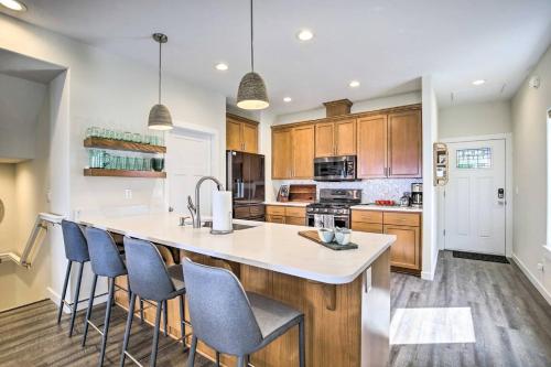 a kitchen with wooden cabinets and a large island with bar stools at The Moby House Coastal Retreat with Ocean Views & Hot Tub in Depoe Bay