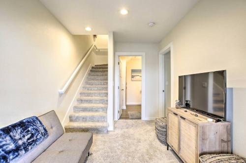 a living room with a couch and a tv at The Moby House Coastal Retreat with Ocean Views & Hot Tub in Depoe Bay