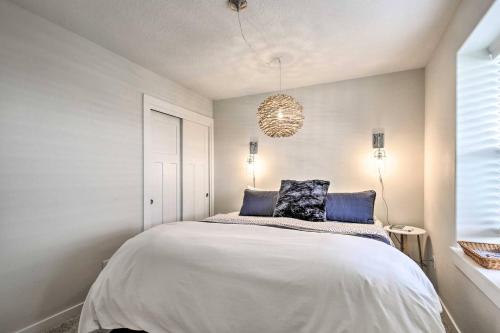 a bedroom with a large white bed with blue pillows at The Moby House Coastal Retreat with Ocean Views & Hot Tub in Depoe Bay