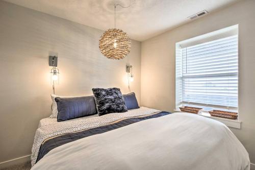 a bedroom with a large bed and a chandelier at The Moby House Coastal Retreat with Ocean Views & Hot Tub in Depoe Bay