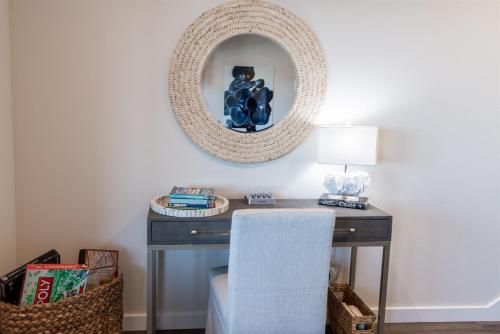 a desk with a mirror and a lamp on it at The Moby House Coastal Retreat with Ocean Views & Hot Tub in Depoe Bay