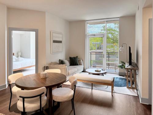 a living room with a table and a couch at The Stay 1 - Tysons Corner in Howard