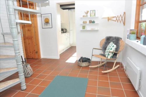 a living room with a chair and a floor at 20038-Ulfborg-Knakvej-8 in Vedersø Klit