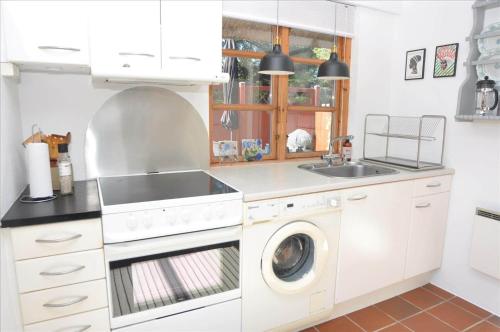 a kitchen with a washing machine and a sink at 20038-Ulfborg-Knakvej-8 in Vedersø Klit