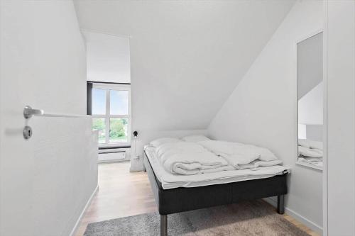 a bedroom with a bed in a white room at BV262-Billum-Ho-Bugt-Vej-6 in Billum