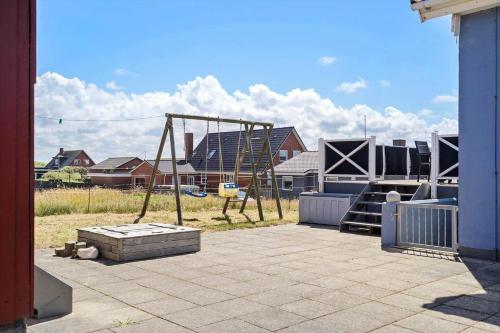a playground with a swing set in a yard at 70869-Ulfborg-Magevej-5 in Thorsminde