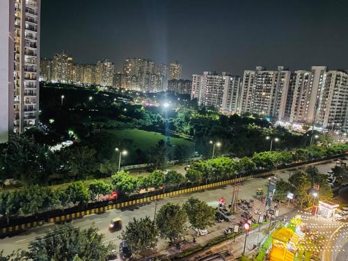 a view of a city at night with buildings at Premium 2BHK Stay Spacious Stylish in Noida in Noida