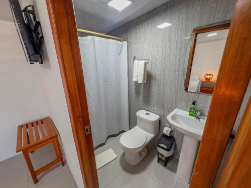 a bathroom with a toilet and a sink at Galapagos Dreams in Puerto Ayora