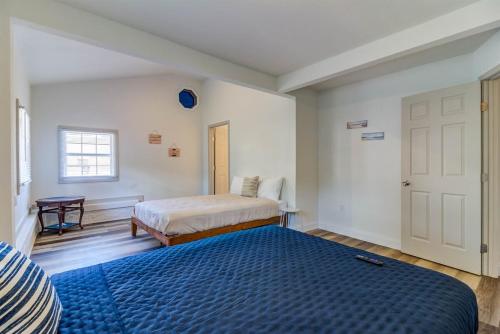 a bedroom with a large blue bed and a door at Downtown Gulfport- Walk to the Beach, Casinos, Restaurants in Gulfport